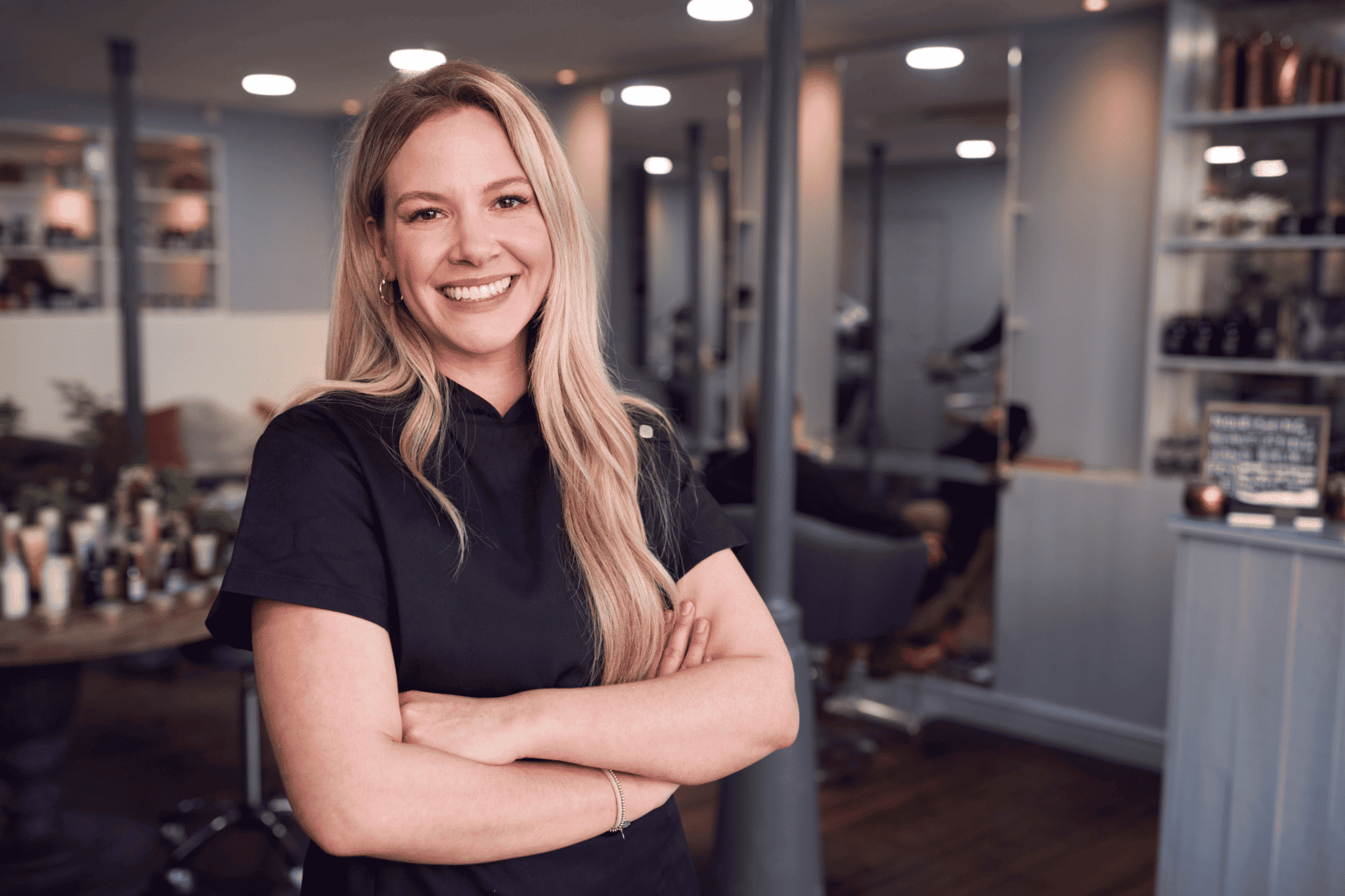 Beauty salon owner smiling in black professional attire. Beauty salon owner smiling in black professional.