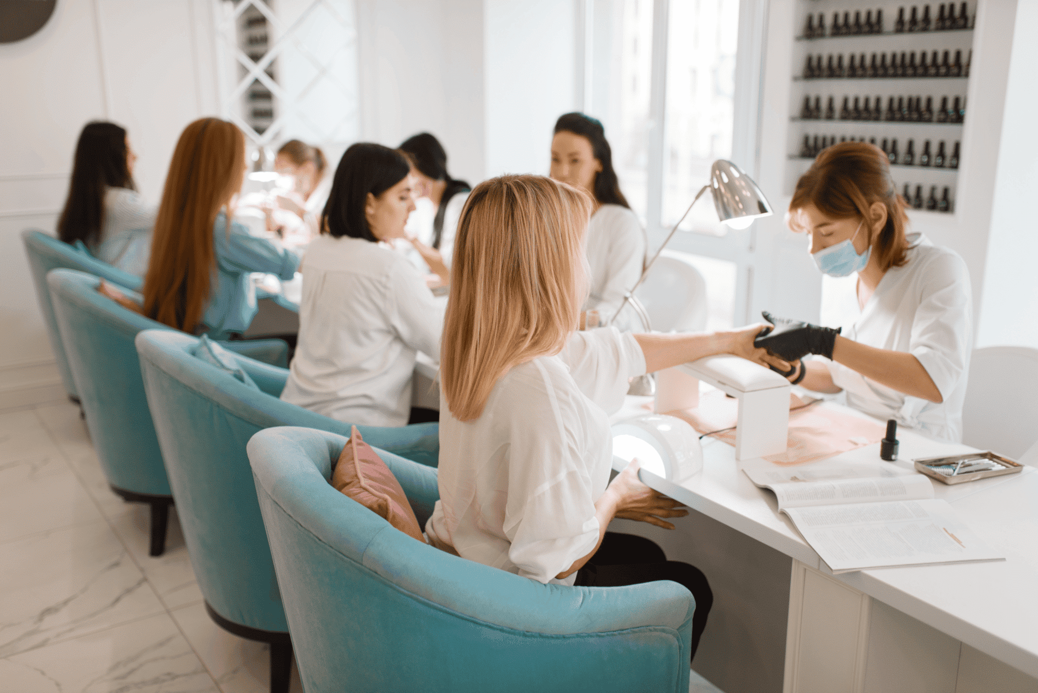 Nail salon professionals serving clients in a salon nail salon professionals serving clients in a salon