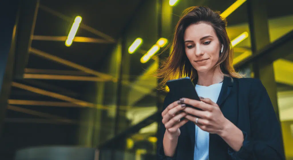young business woman sending sms in professional atire