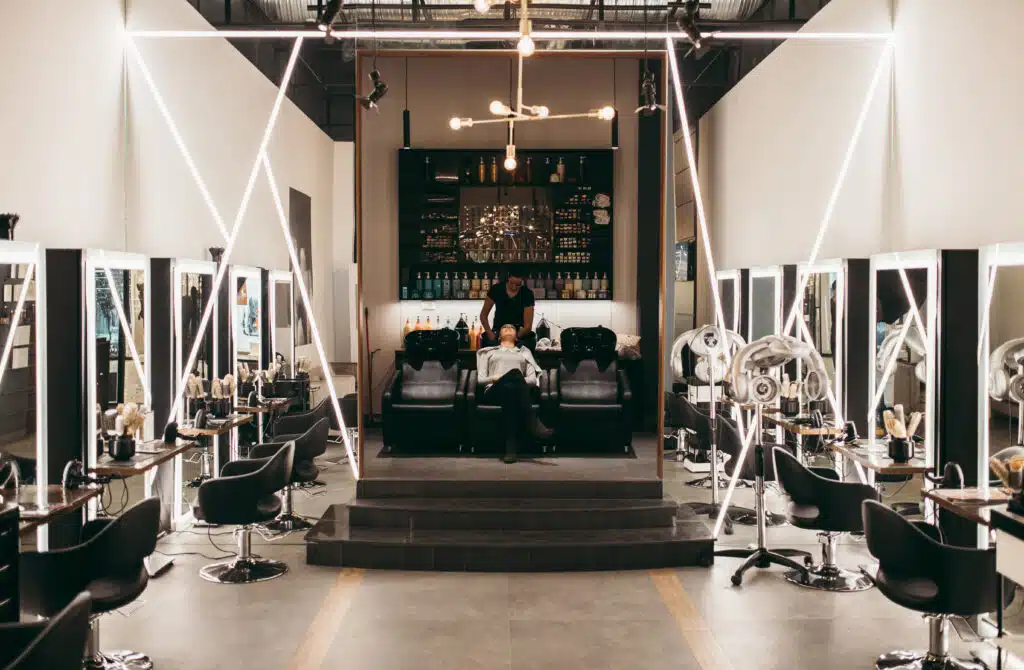 big hair salon with stylist washing hair of client