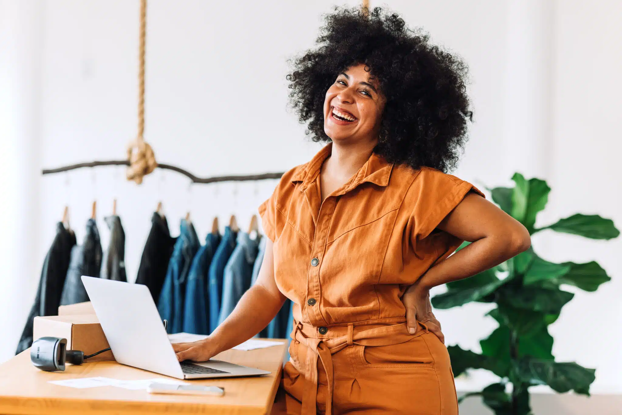business owner smiling and working with laptop