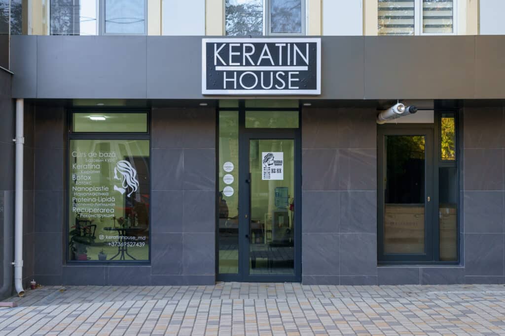 exterior street front of a beauty hair salon façade with salon name right at the top