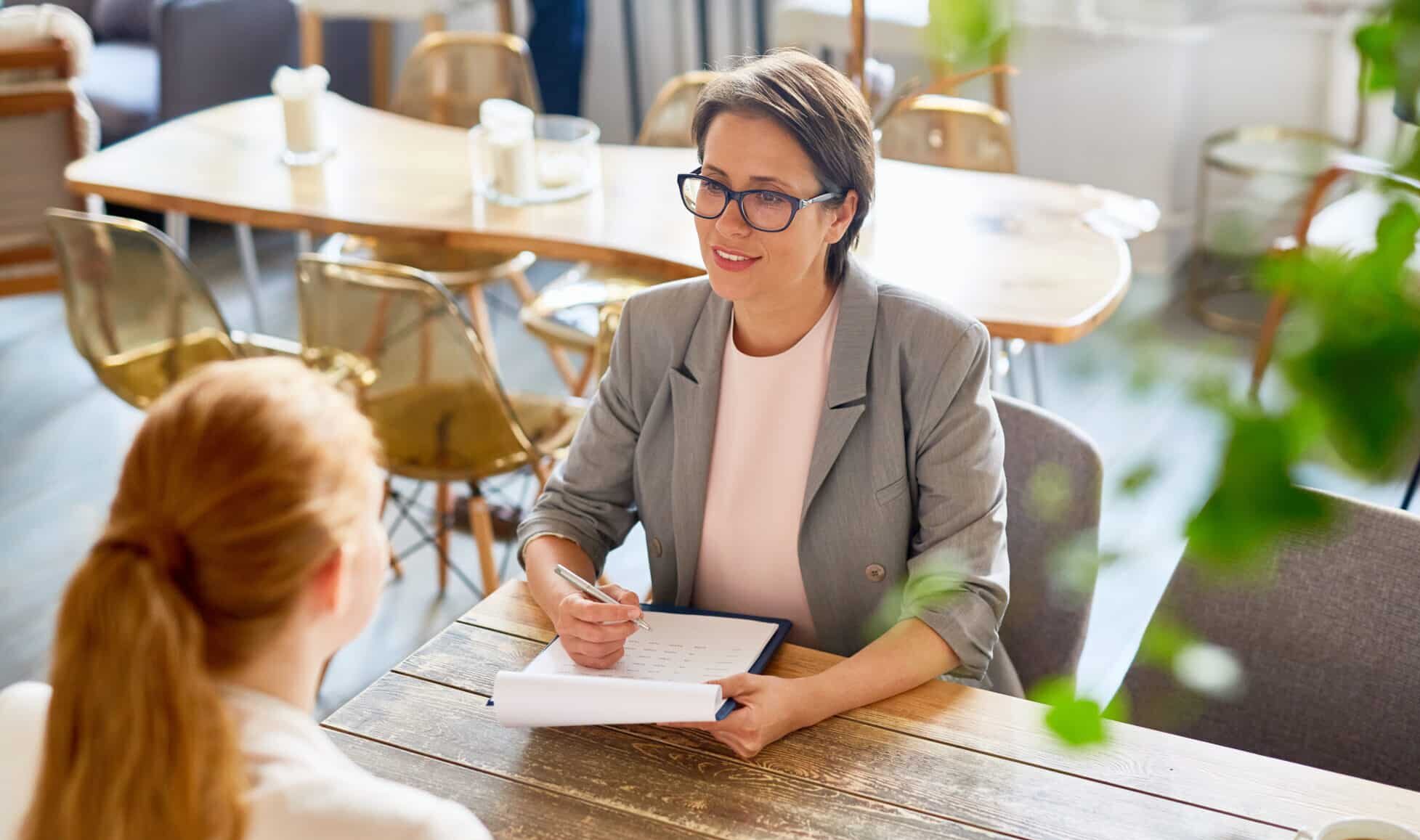 small business owner interviewing young candidate