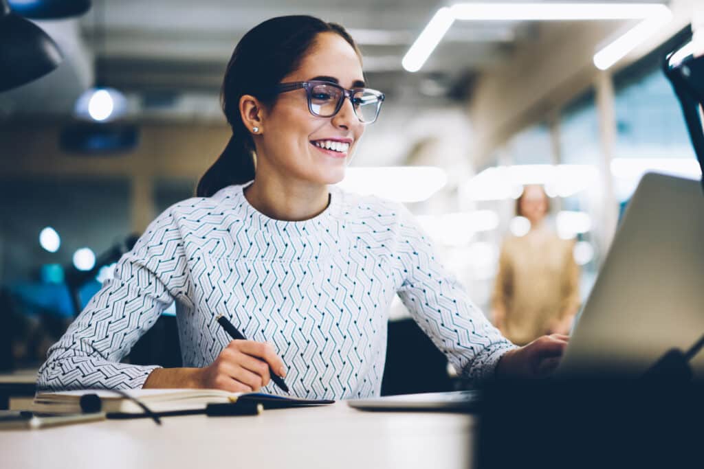smiling secretary in office managing work