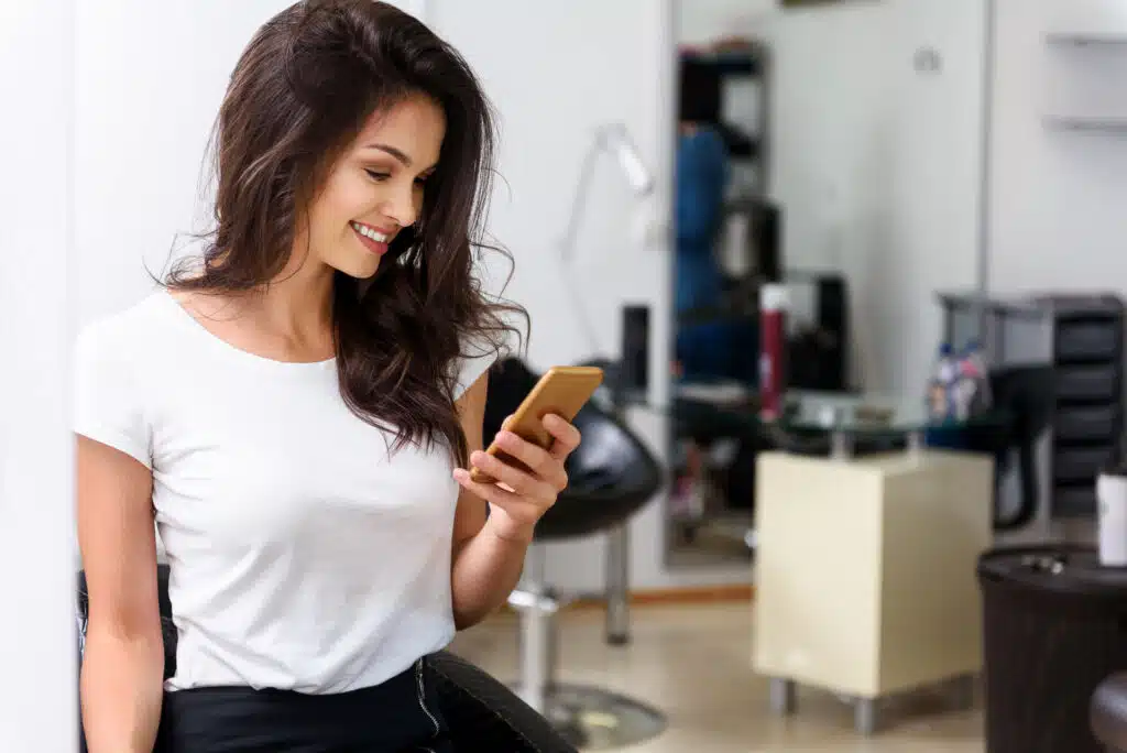 customer receiving text messages in a salon