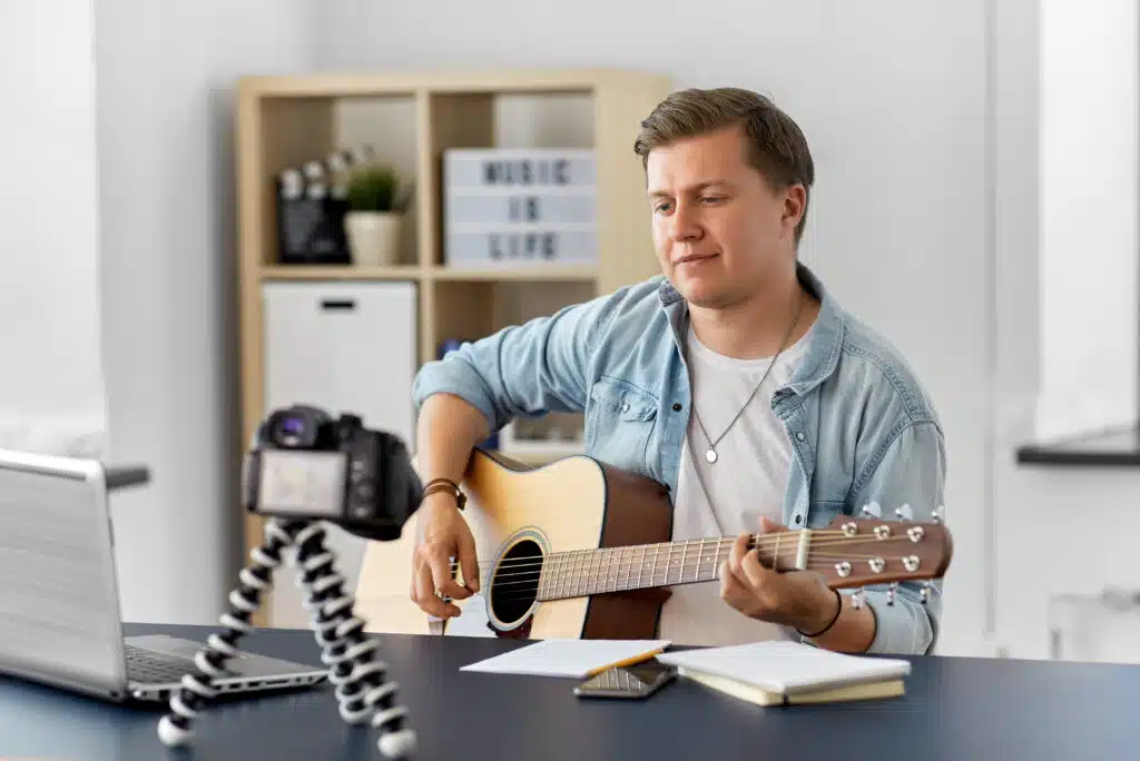 online course creater with camera playing guitar