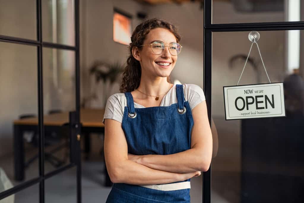 small business owner standing at cafe entrance