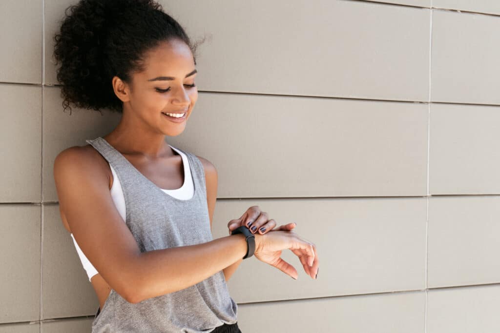 girl checking her wrist fitness tracker