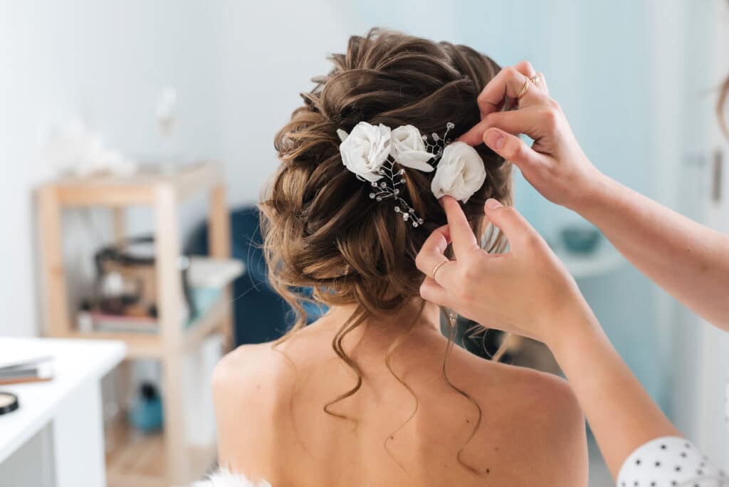 bride getting hair done for the wedding day