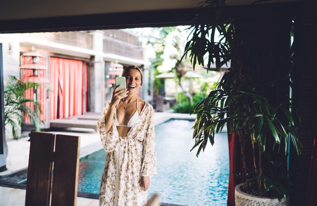 Happy spa customer with mobile phone